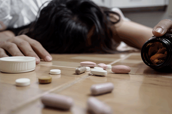woman overdosing on pills